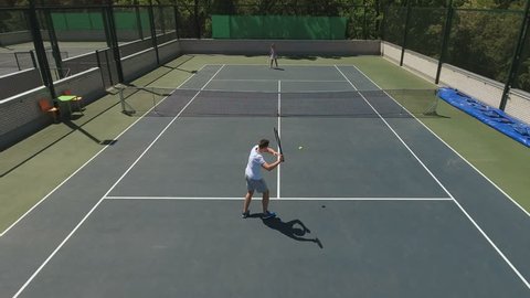 Attractive young man and woman play the tennis game