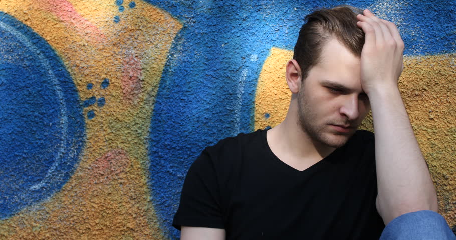 Serious Handsome Guy Looking Sad Have Hands on Head Worried Moment Graffiti Wall
