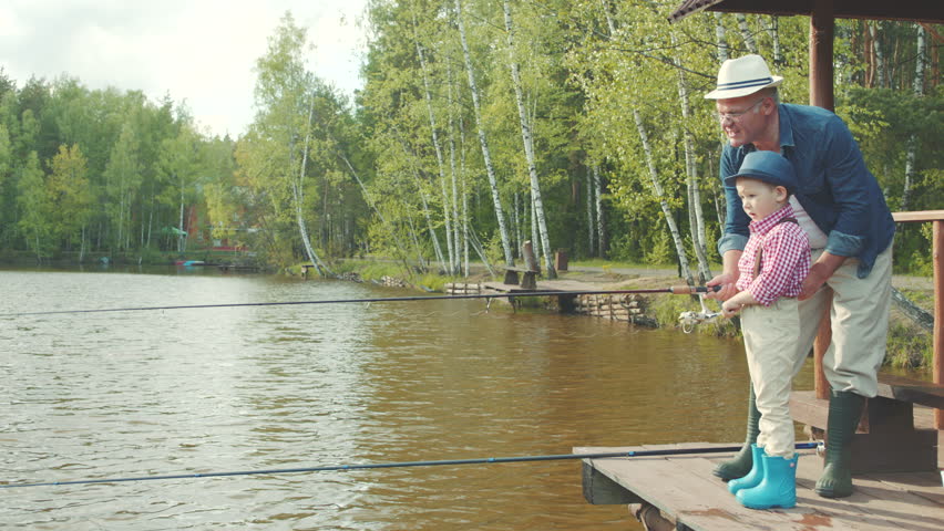 Little boy and his grandfather on fishing at the lake Royalty-Free Stock Footage #29472652
