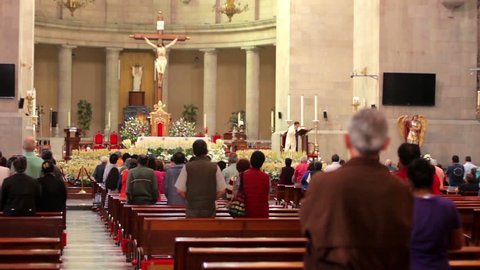Toluca, Mex-CIRCA August 2017: People listening to the priest during mass inside the San Jose Cathedral. Most mexicans profess the Catholic religion.