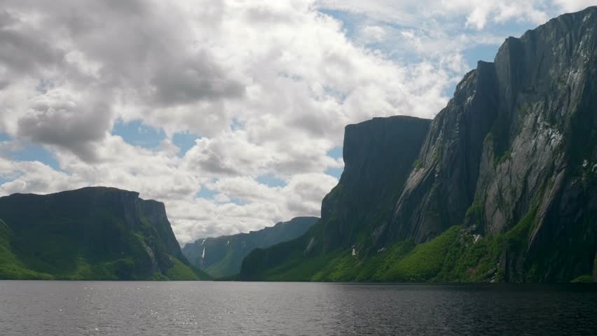 A boat travelling through amazing scenery in the Western Brook Pond in Gros Morne National Park in Newfoundland Canada