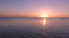 Drone video at sunset showing beach and boats, West End, Roatan Honduras