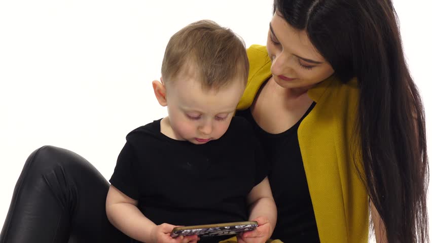 Mother holds her son on her lap and trains him. White background
