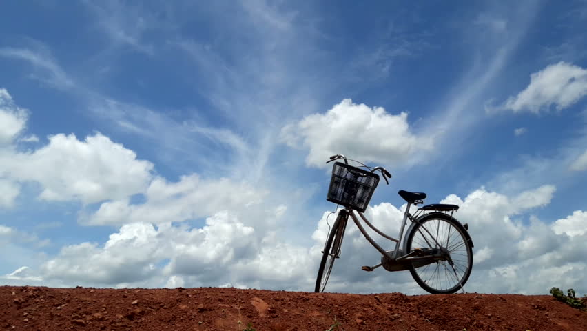 Timelapse Beautiful sky, moving clouds and bicycle scene.