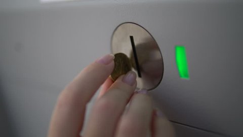 Woman Hand Dropping Coin into Vending Machine. Paying for something by Cash into 
cash Dispenser. Put coin into a Slot of Validator. The Green Light 
Turned off after Payment. Financial Operation.