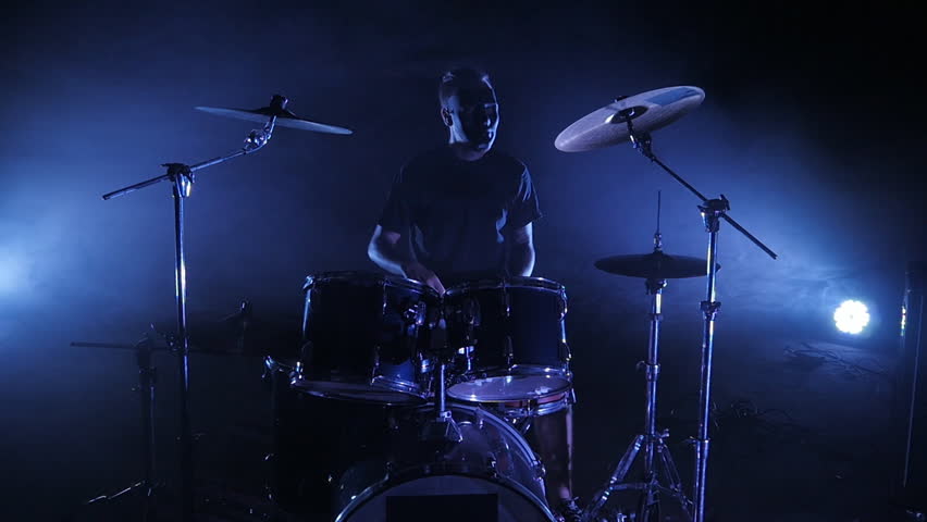 The drummer plays the drum set on the stage. Shot in a slow motion. Music video punk, heavy metal or rock group. Royalty-Free Stock Footage #29491315