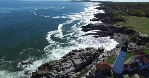 Lighthouse on Rocky Coastal Point Overlooking Atlantic Ocean - Aerial Footage of Portland Head Lighthouse, Maine
