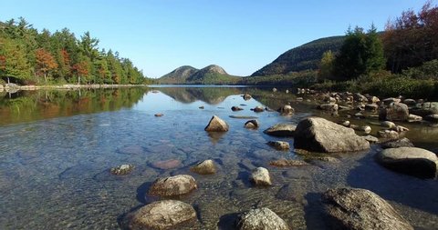 Still Water Pond Fly-Over with Rocks Visible Below Water's Surface - Aerial Footage of Jordan Pond in Mount Desert Island, Maine, USA