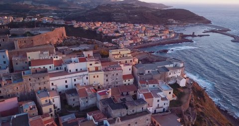 Video from above, Aerial view of Castelsardo city at sunset in Sardinia, Italy.	