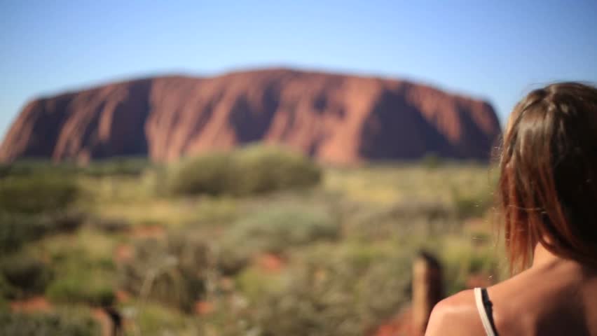 Woman hiking frames landscape into heart shape
Young woman in Australia hiking makes a heart shape finger frame to spectacular landscape.