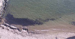 Aerial drone footage of ocean waves reaching shore. Beach on aerial drone. Beach on top view.Aerial shot of waves in the beach