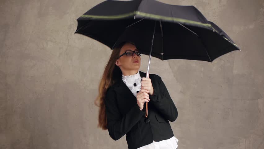 Businesswoman with umbrella showing happiness, money concept