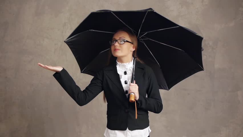 Businesswoman holding umbrella and checking rain, money concept