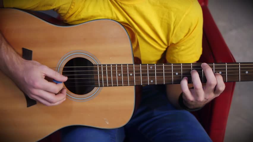 Bard musicians hands playing song on guitar