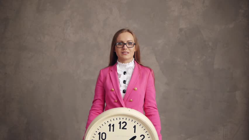 Happy businesswoman raising up retro clock, time concept