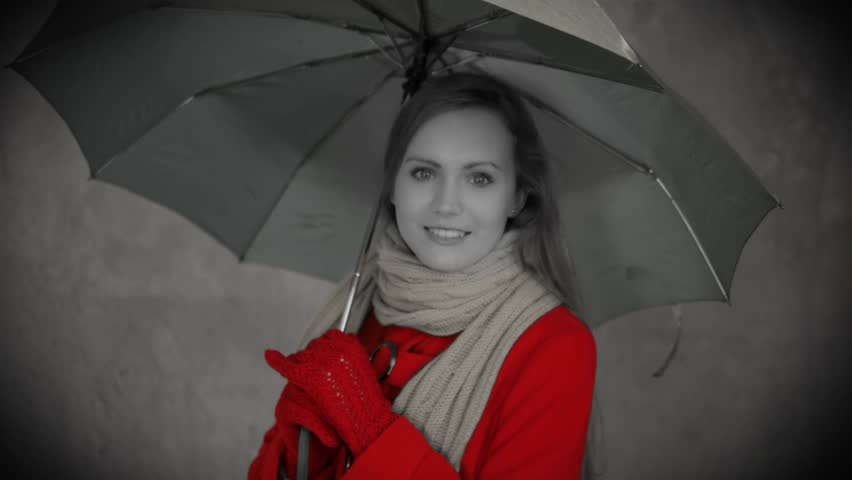 Young woman with umbrella in retro style