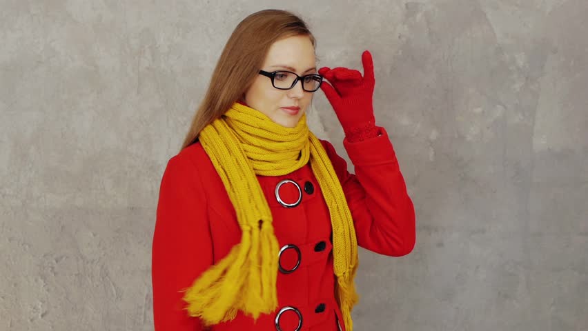 Young smiling woman in red coat