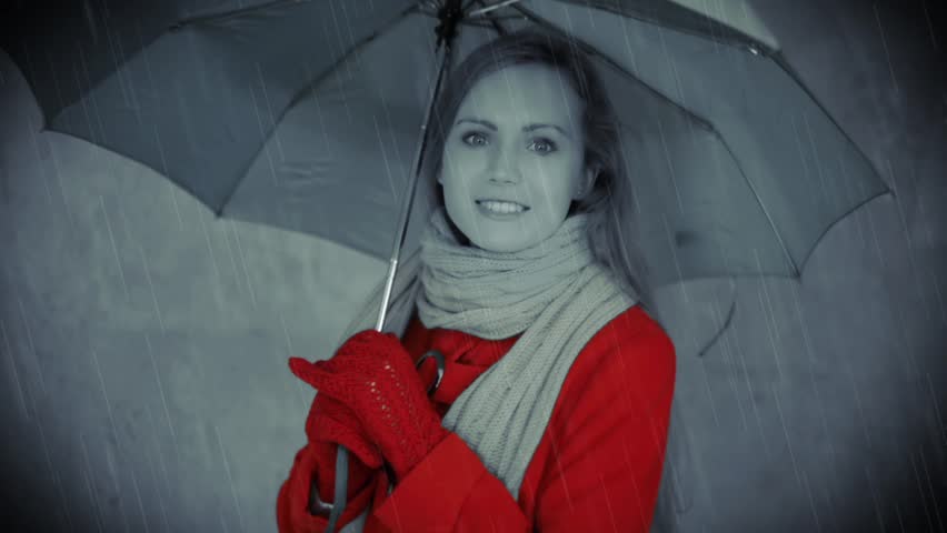 Retro style video: pretty woman in red coat under umbrella