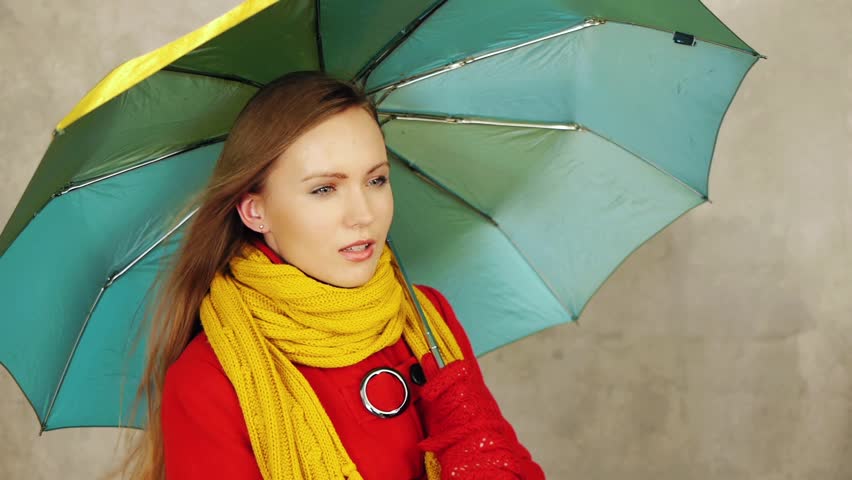 Pretty woman with umbrella at autumn