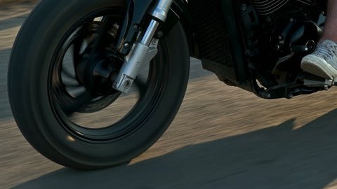 closeup of a wheel of the motorcycle in motion,which goes to the motorcyclist on the highway