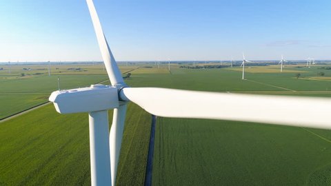 Aerial Close Up view of Wind Turbine on countryside green field