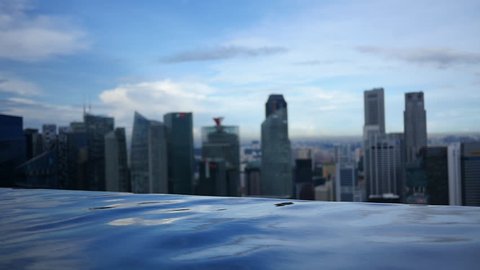 Infinity Pool Overlooks City Skyline - The edge of an infinity pool creates a line of water above which there is a great view of a city skyline