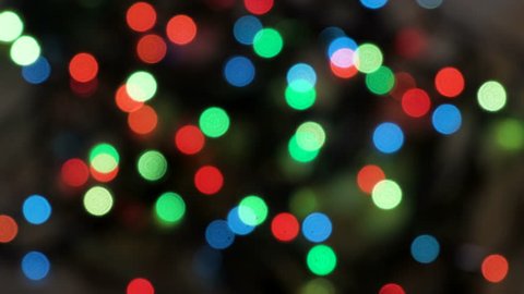Flashing colored lights in a blur. The bokeh effect. Electric Christmas tree lights. Footage clip 4k