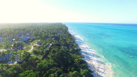 Aerial view of tropical paradise beach with white sand and turquoise crystal clear water of blue lagoon at sunset, a lot of palm trees on shore - Paje, Zanzibar, Tanzania, Africa, Indian Ocean, 4k UHD