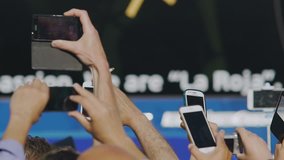 Hands of curious crowd taking photos with smartphones, addiction to gadgets