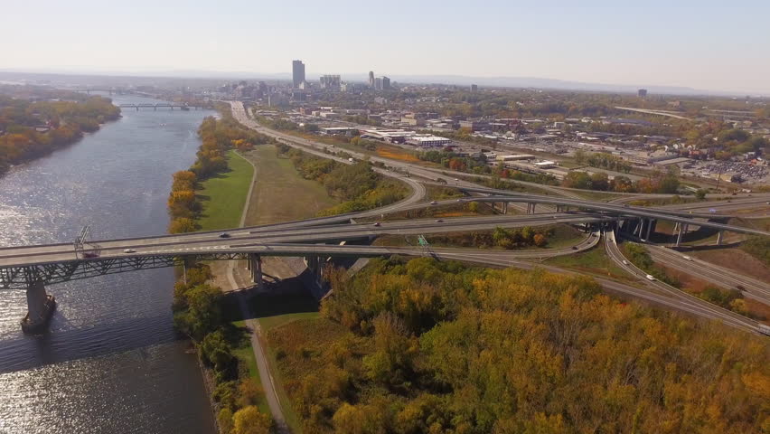 Moving aerial shot towards the City of Albany panning towards highway. I-90