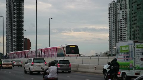 BANGKOK, THAILAND - AUGUST 7, 2017 : BTS electric sky train, mass railway transportation on Taksin bridge with other vehicles, car, bus, motorcycle in evening, Bangkok Thailand