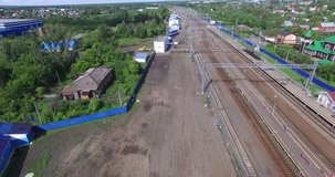 4K aerial view drone video of Petushki station railway tracks, old railway station building, steam engine train monument in small town 100 km east of Moscow, Russia on summer morning