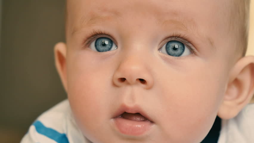 Portrait of cute blue-eyed baby is crying