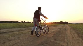 Boy teenager riding a bicycle. Boy teenager riding bicycle goes nature along the path steadicam shot motion video