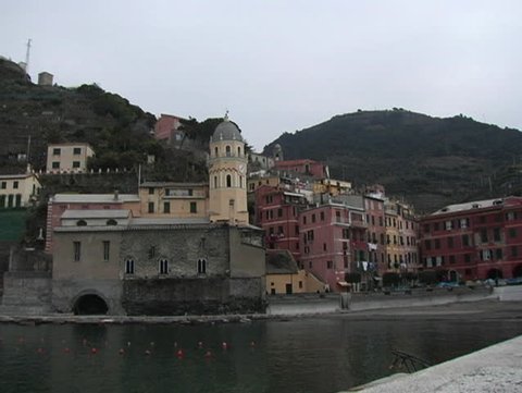 Clock tower, church, and harbor of Vernazza, Italy.