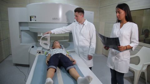 VINNITSA, UKRAINE, JULY 27, 2017: Magnetic resonance imaging. A child before a medical procedure in a ct-scanner. The child is scanned on a tomograph.