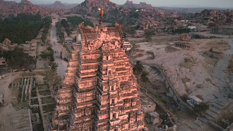 Sunset overlooking the top of the ancient Virupaksha temple, Hampi, Karnataka, India. The river and the temple complex in the background