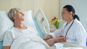 Pleasant caring doctor supporting his aged inpatient