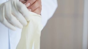 Close up of a professional doctor putting on the gloves
