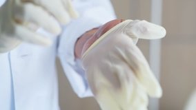 Close up of a professional doctor wearing medical gloves