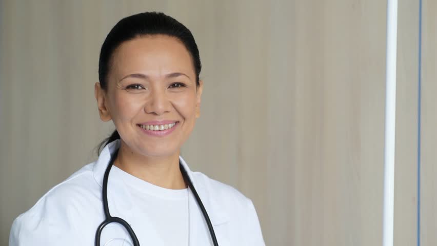 Joyful female doctor welcoming her patients