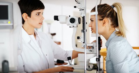 Patient or customer at slit lamp at optometrist or optician