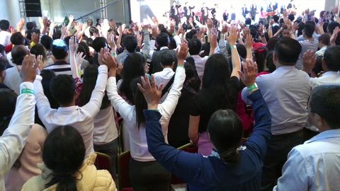 HO CHI MINH CITY, VIETNAM - JAN 10, 2017: People sing at the Christian conference held by Messenger International. 