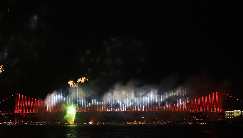 Colorful fireworks all over the Istanbul sky. View of Bosporus Bridge. Pan from