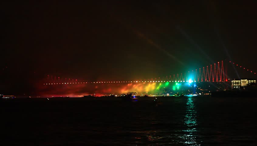 Colorful light beams over Bosporus Bridge on October, 29 Festival Day in
