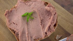 Liverwurst rotating on a wooden plate (not loopable; 4K)