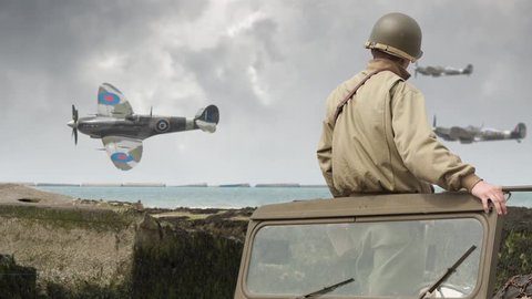 Spitfires fly past a World War 2 American Soldier on the beach as he stands in his vehicle