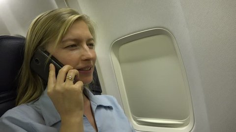Smiling Business Woman Talking At Mobile Phone, Partner Connection Inside Airplane