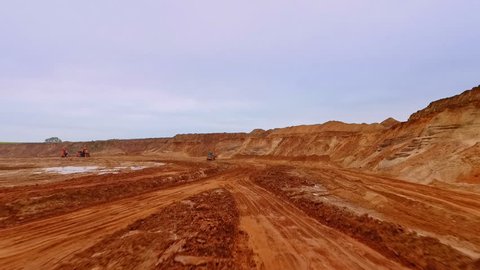 Sand work in mining industry. Aerial view of road to industrial territory sand mine. Mining equipment on industrial area