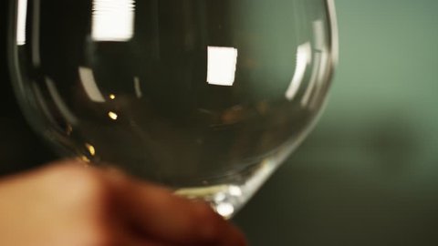 close up of white wine pored in to a wine glass
